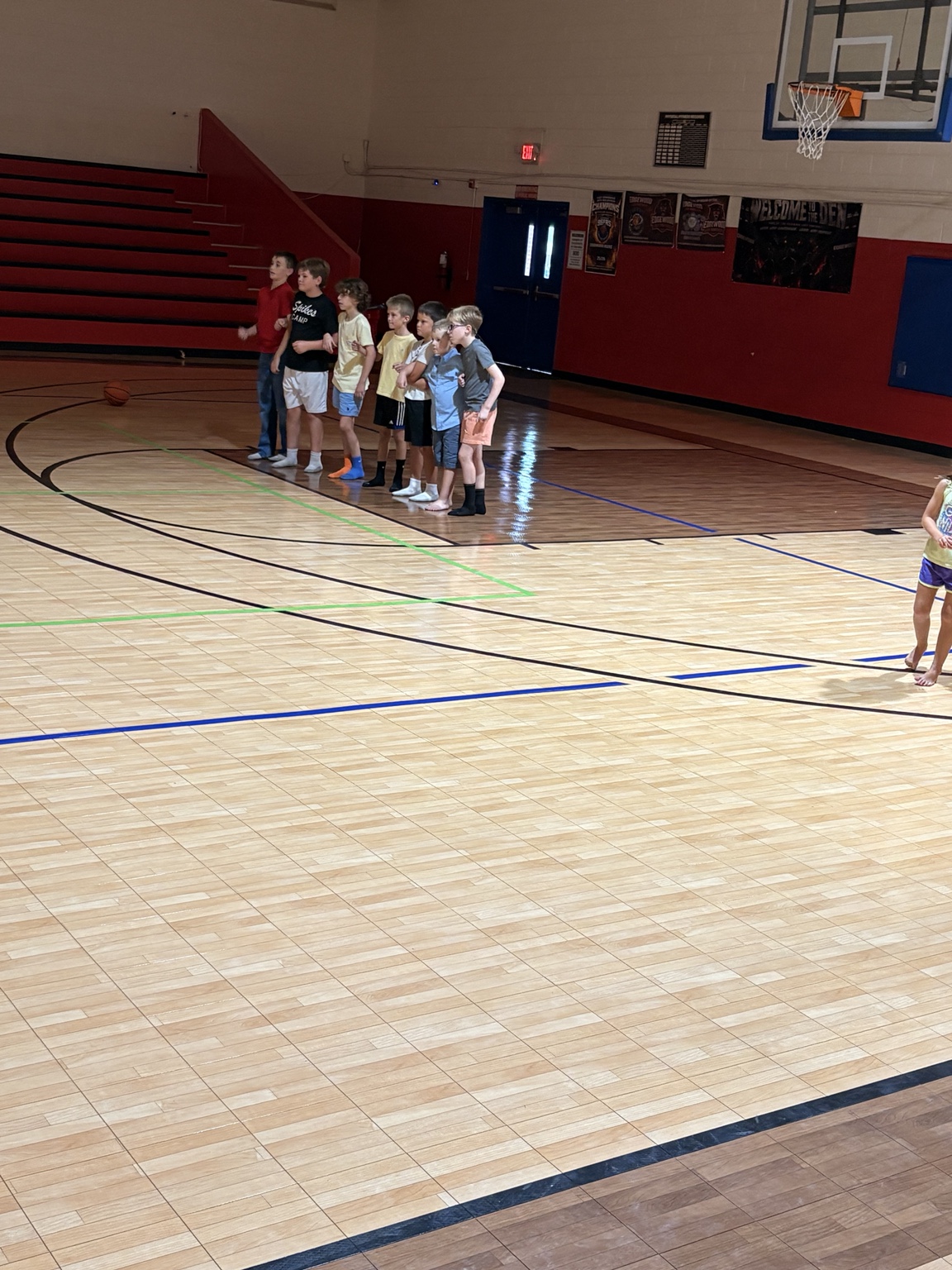 A group of children lined up together for an activity in the gym