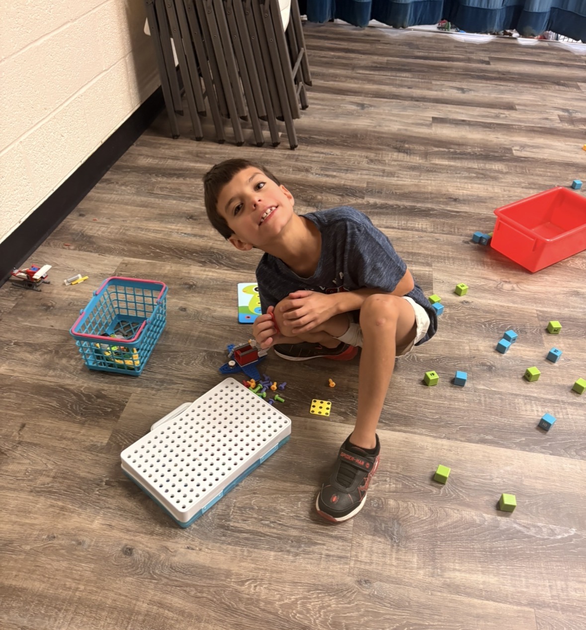 Child playing with a pegboard and blocks