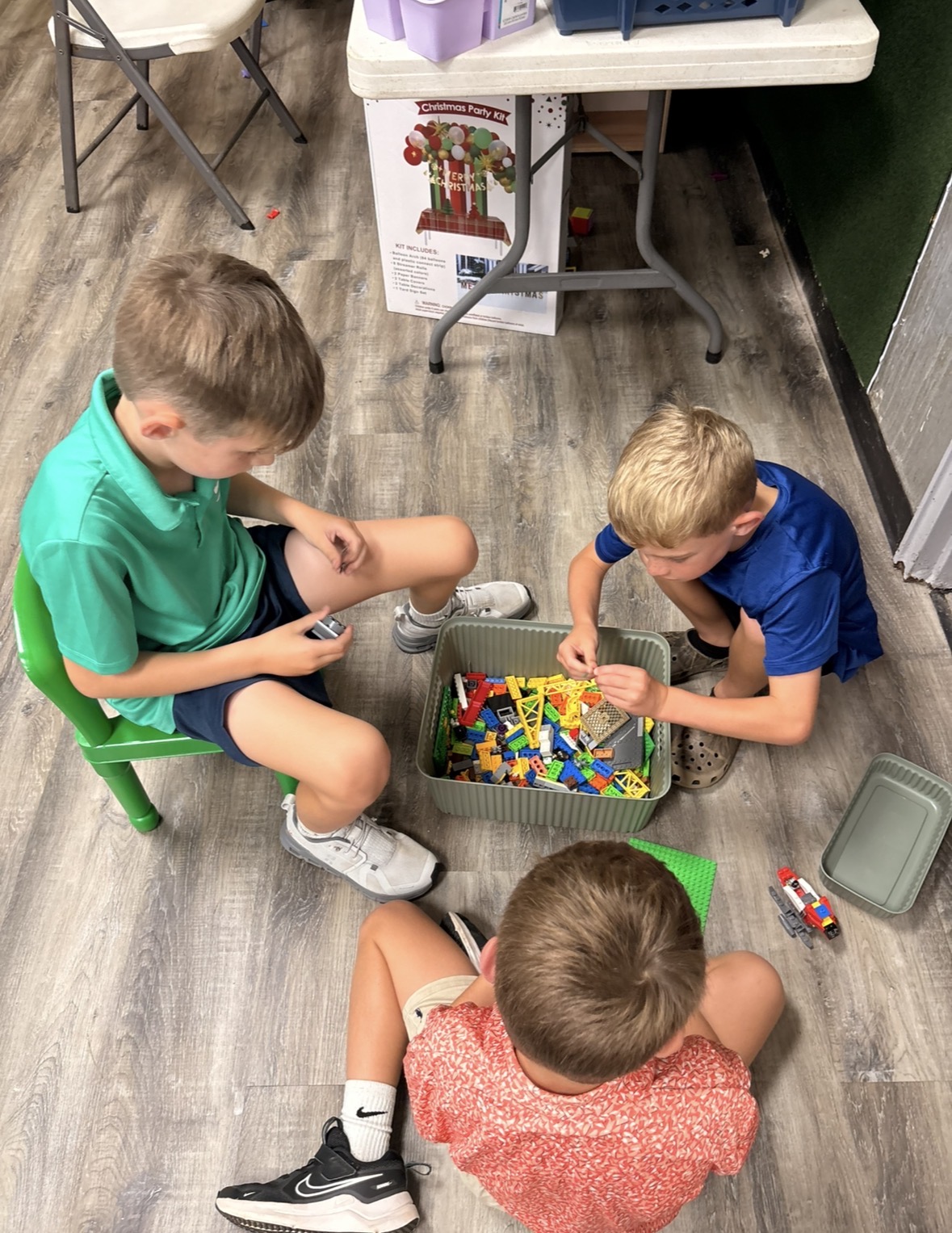 Children building together with colorful blocks