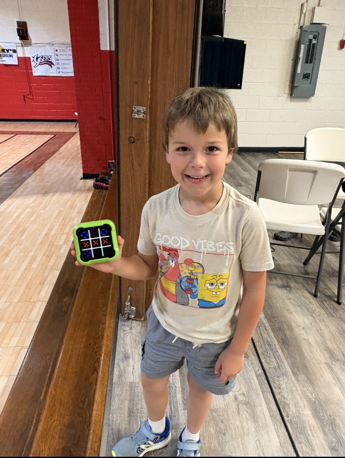 Child proudly showing a game at HomeBase96